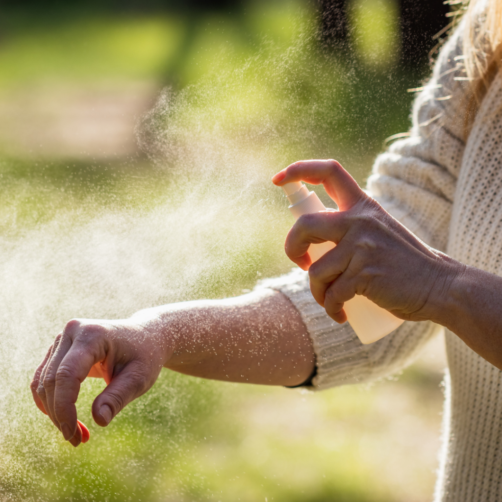 person applying mosquito repellent to arm picture for blog titled what is the best outdoor mosquito killer for large areas