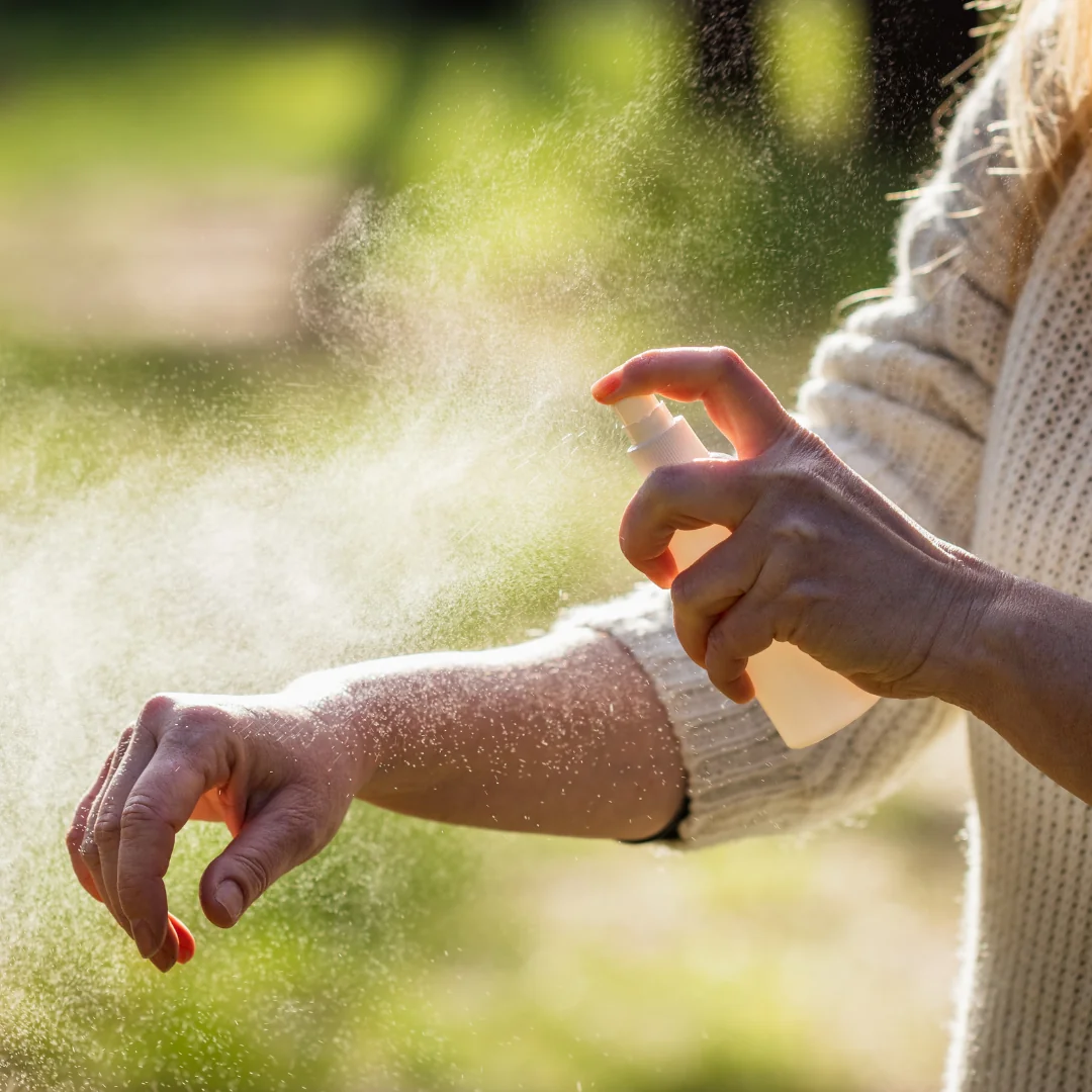 person applying mosquito repellent to arm picture for blog titled what is the best outdoor mosquito killer for large areas