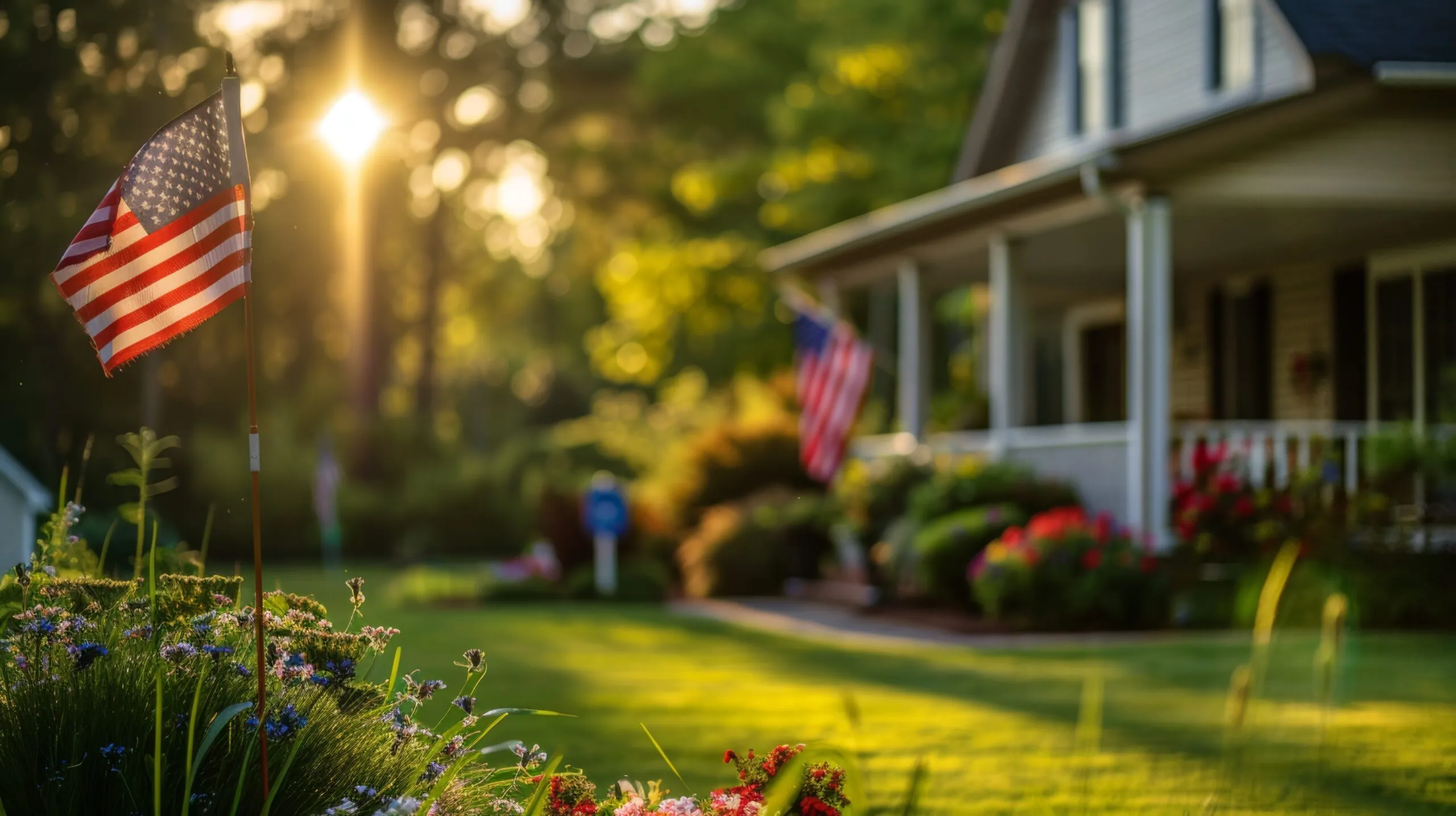 The American flag is flying on a corner of a residential house with a blurred background in the sunny afternoon military discount pest control photo